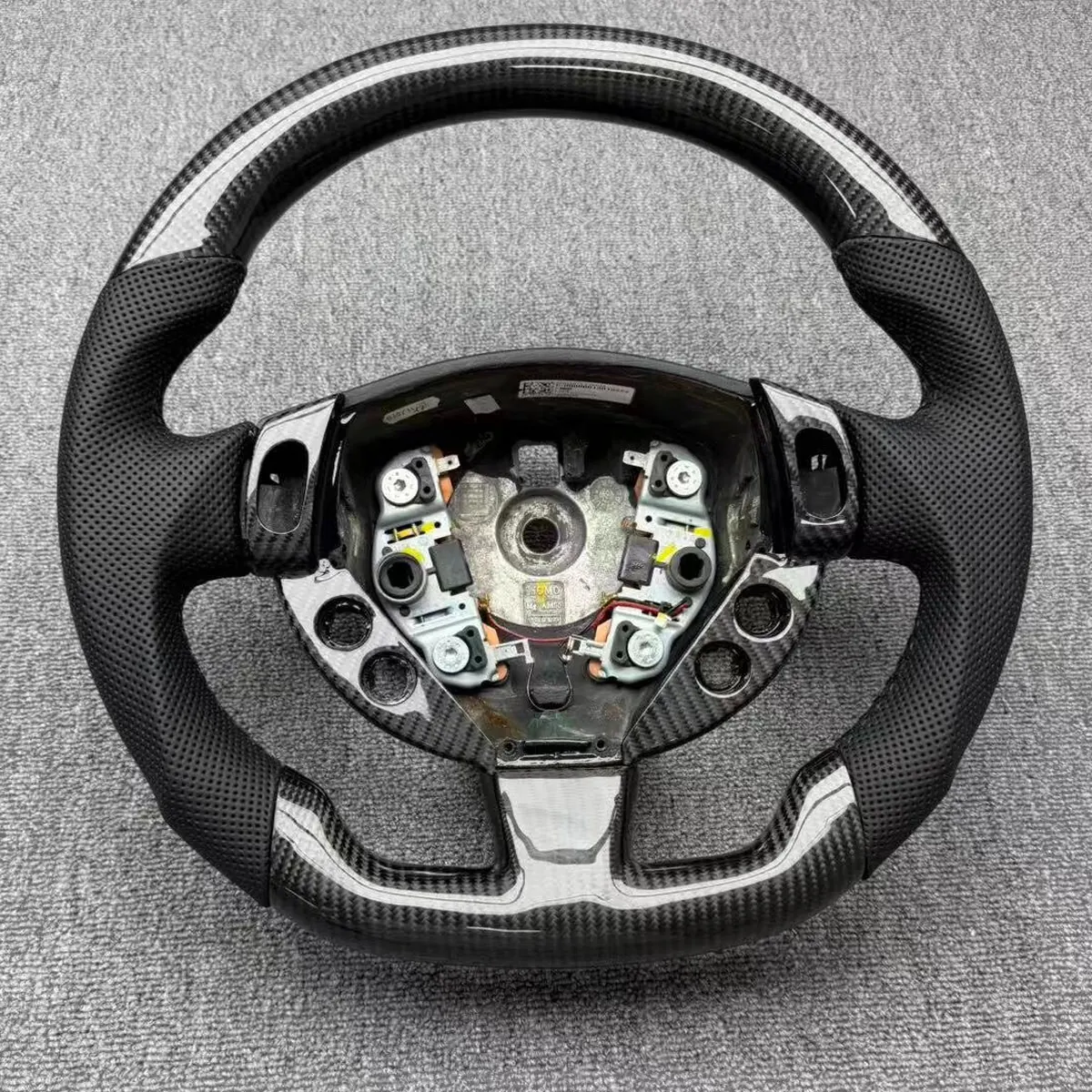 Maserati Levante carbon fiber steering wheel, front view with the airbag module removed