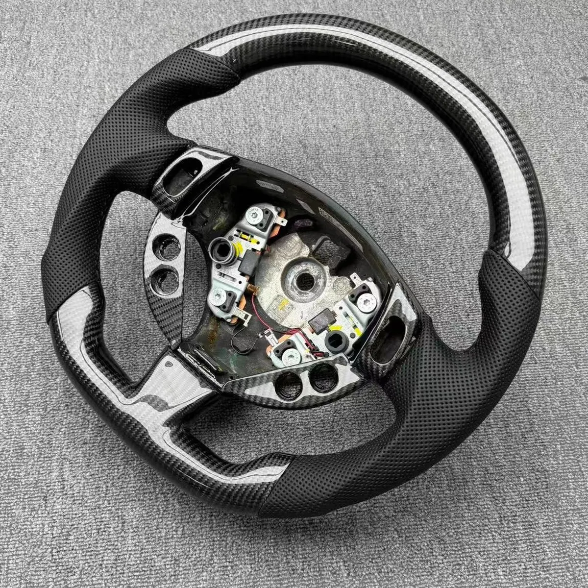Maserati Levante flat-bottom carbon fiber steering wheel, wide view of the rim and centre boss